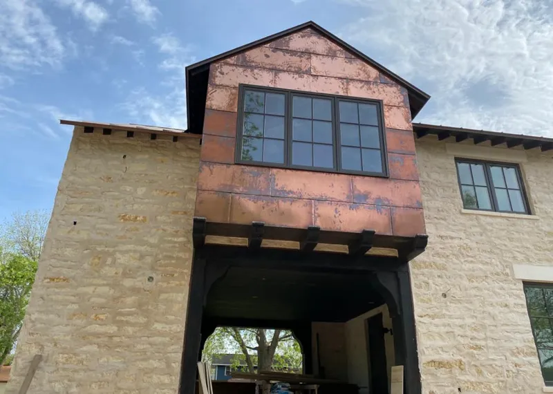 Copper metal panel facade on a stone building for Roof Repair in Davie