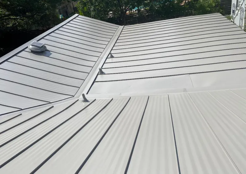 Solar attic fan installed on a metal roof for Roof Ventilation in Davie